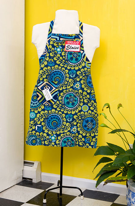 Clever dress form models beautiful apron.