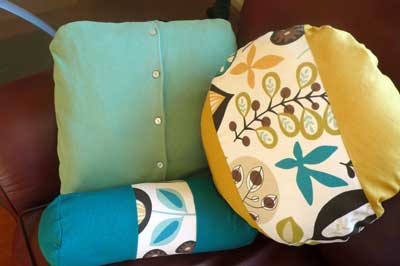 Upcycled sweater pillow with other accent pillows.